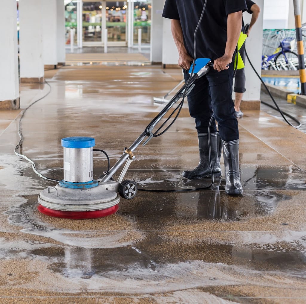 Asian worker cleaning sand and the exterior walkway 1