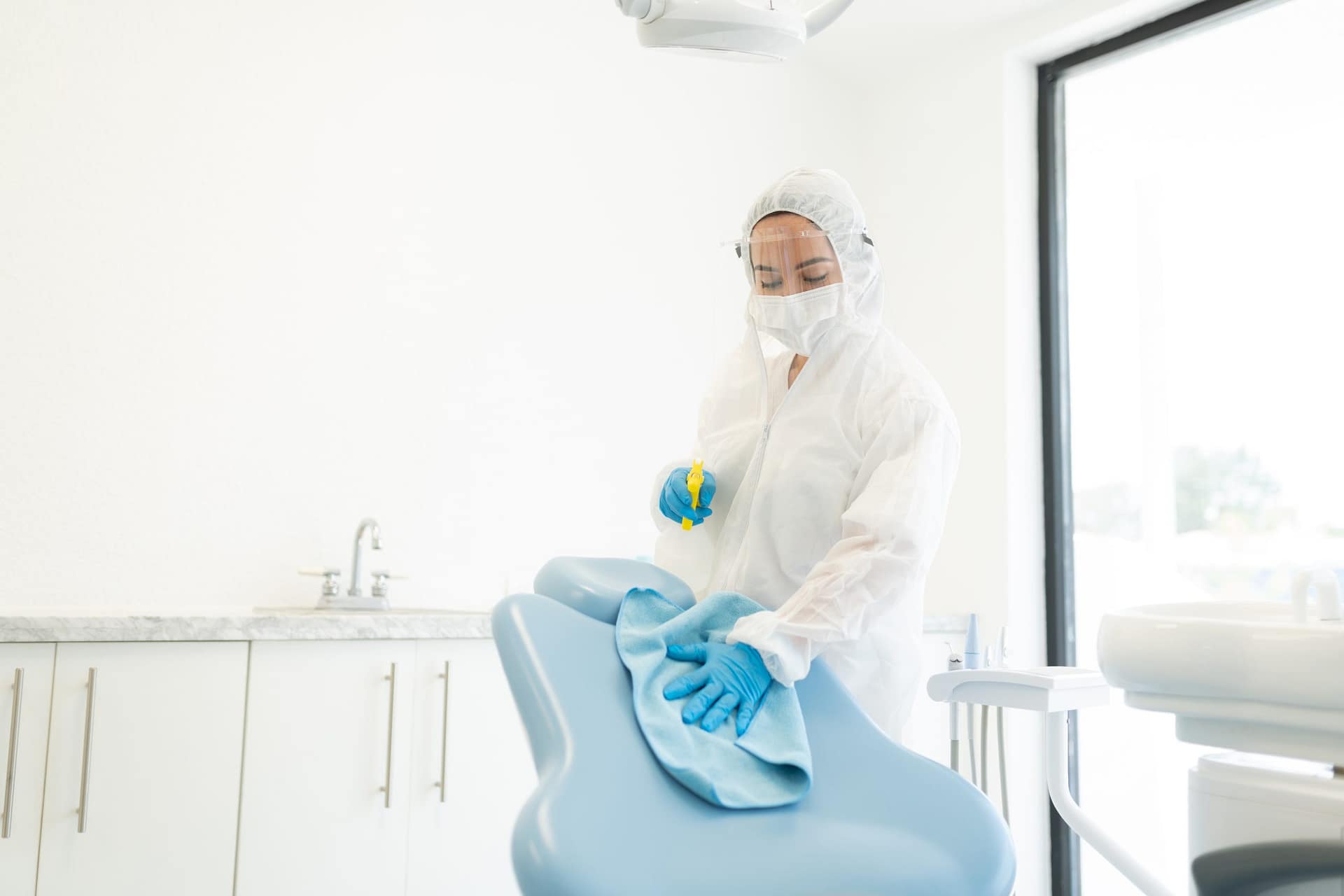 disinfecting dental clinic while wearing suit 2025 09 08 11 12 58 utc