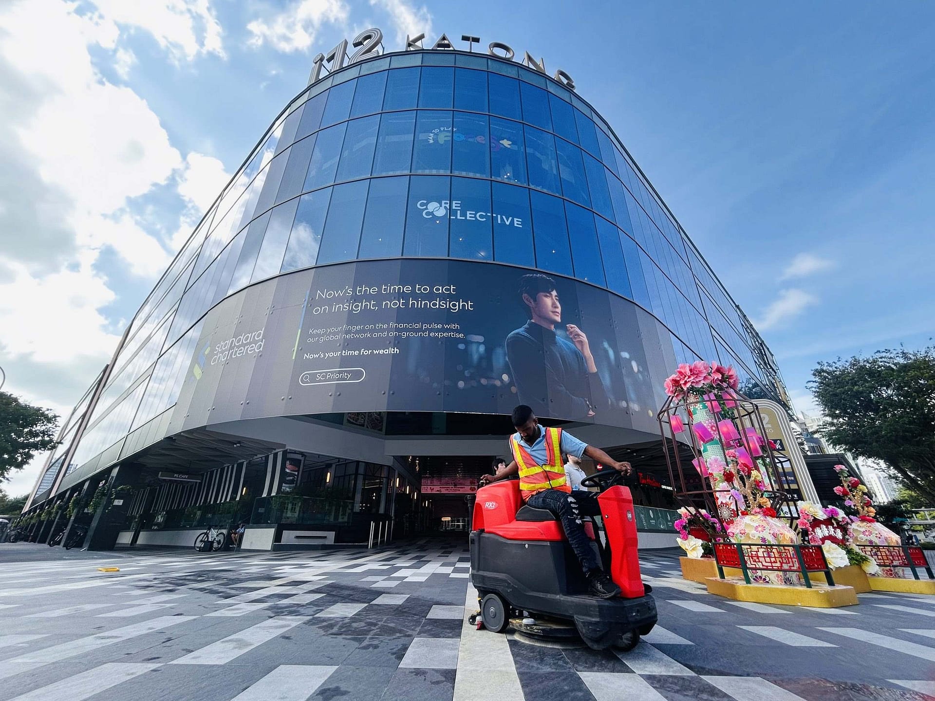 Shopping Mall / Retail Cleaning - Man operating outdoor vacuum sweep machine