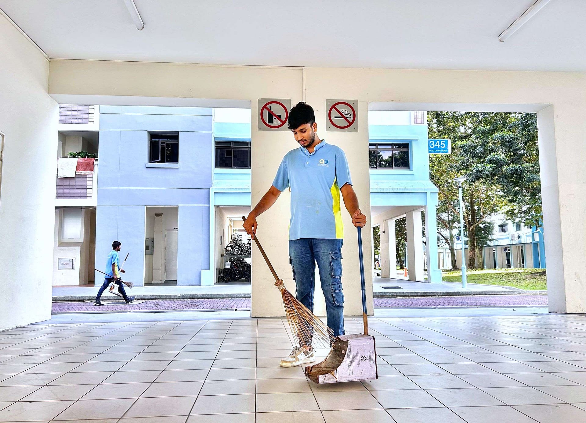 Conservancy Cleaning - Man sweeping HDB
